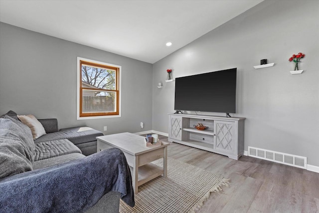 living room with visible vents, wood finished floors, baseboards, recessed lighting, and vaulted ceiling