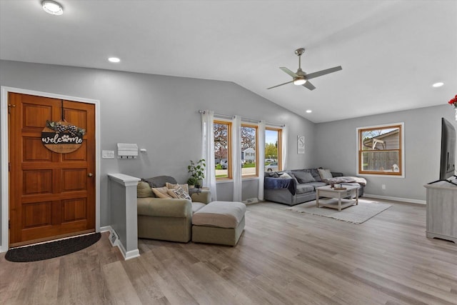 living room with ceiling fan, recessed lighting, baseboards, lofted ceiling, and light wood-type flooring