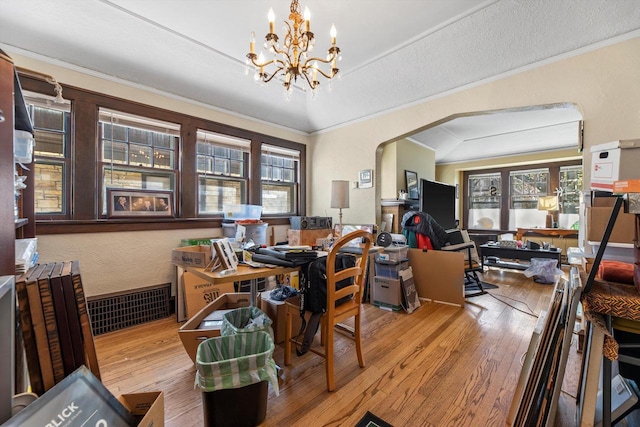 2562 N 68th St Unit 2564, Wauwatosa, WI 53213 - dining space with wood finished floors, plenty of natural light, a chandelier, crown molding, and arched walkways
