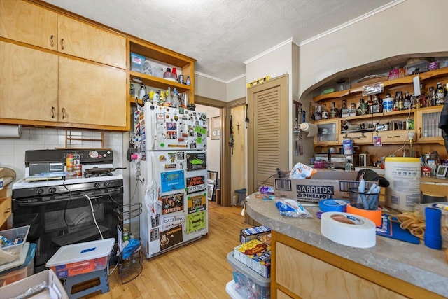 2562 N 68th St Unit 2564, Wauwatosa, WI 53213 - kitchen featuring freestanding refrigerator, range with gas stovetop, open shelves, ornamental molding, and light wood-type flooring