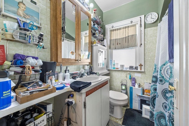 2562 N 68th St Unit 2564, Wauwatosa, WI 53213 - full bathroom with tile walls, decorative backsplash, toilet, and vanity
