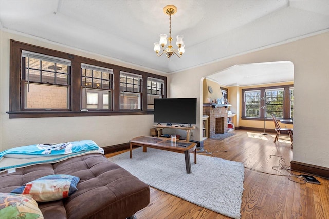 2562 N 68th St Unit 2564, Wauwatosa, WI 53213 - living area with baseboards, wood finished floors, a chandelier, a raised ceiling, and crown molding