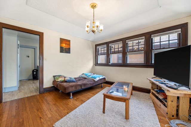 2562 N 68th St Unit 2564, Wauwatosa, WI 53213 - living area with baseboards, plenty of natural light, a chandelier, and wood finished floors