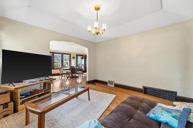 2562 N 68th St Unit 2564, Wauwatosa, WI 53213 - living area with arched walkways, wood finished floors, a chandelier, and baseboards