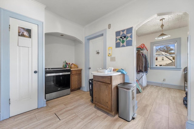 2562 N 68th St Unit 2564, Wauwatosa, WI 53213 - kitchen featuring electric range, arched walkways, light countertops, brown cabinets, and hanging light fixtures
