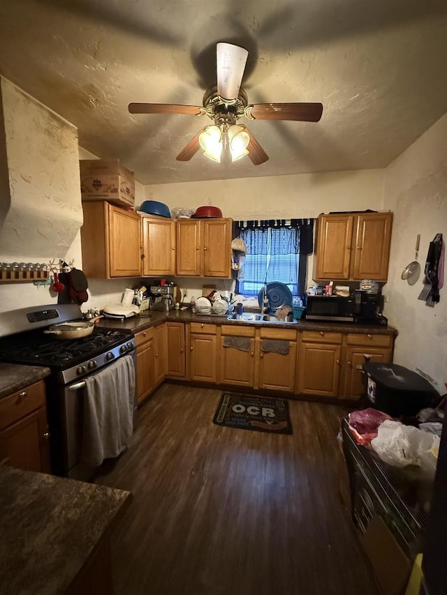 904 Elm St, Beloit, WI 53511 - kitchen with stainless steel appliances, dark wood-style floors, a ceiling fan, dark countertops, and a sink