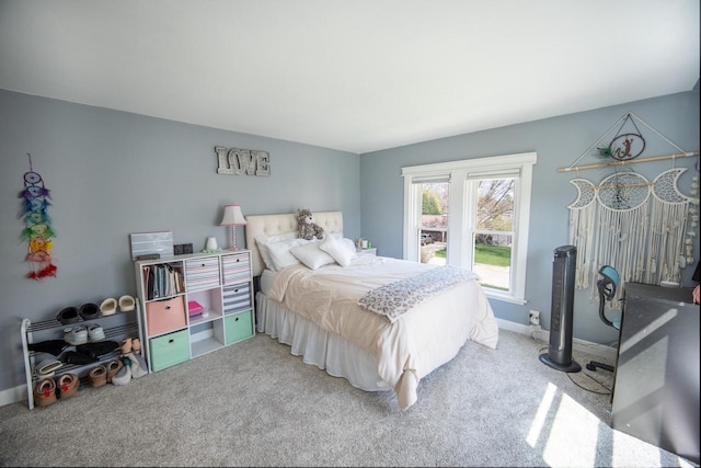 carpeted bedroom featuring baseboards
