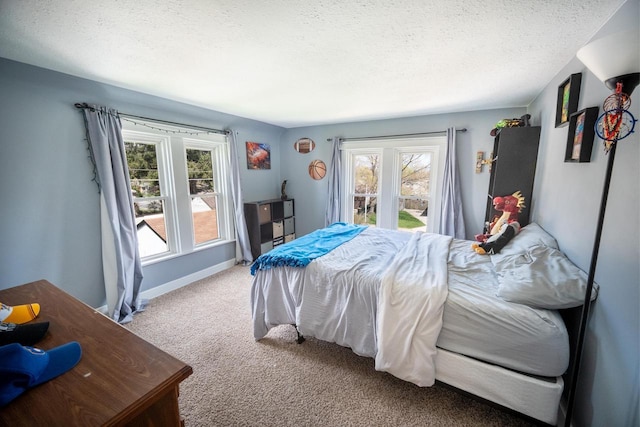carpeted bedroom with baseboards and a textured ceiling