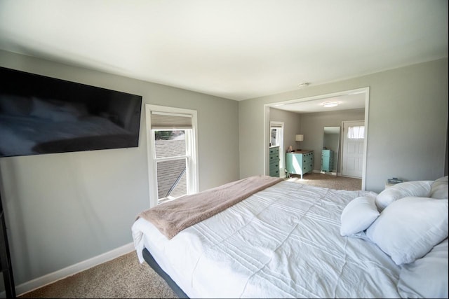 bedroom with baseboards and carpet
