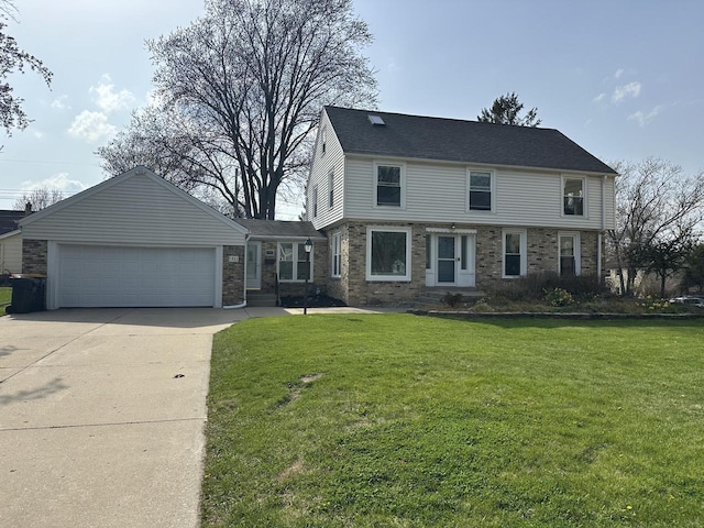 colonial house with a garage, concrete driveway, a front lawn, and brick siding
