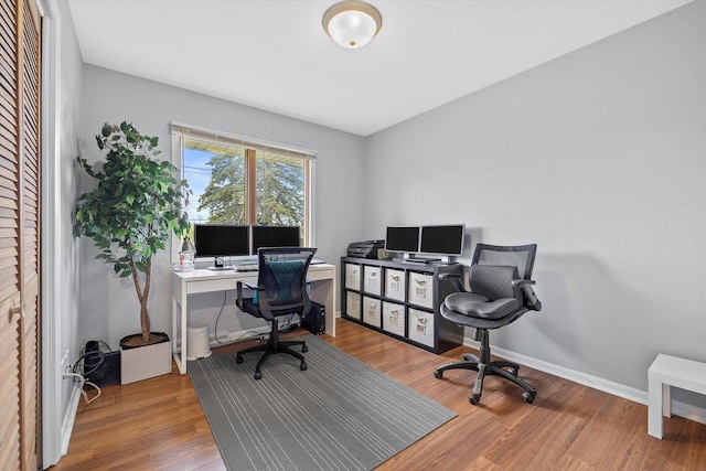 office featuring baseboards and wood finished floors