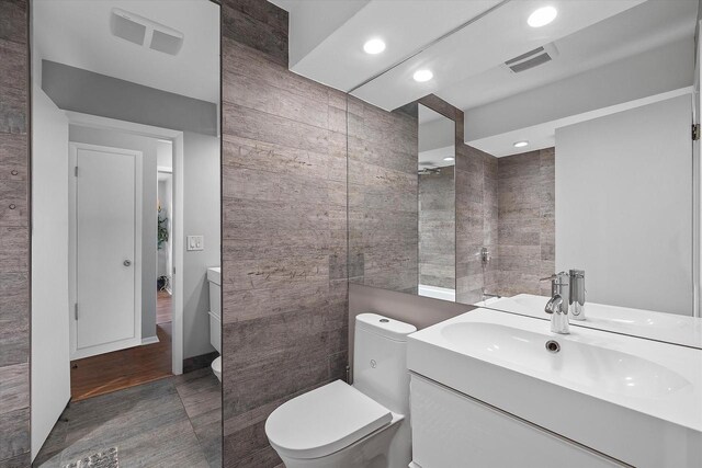 full bath featuring recessed lighting, vanity, toilet, and visible vents