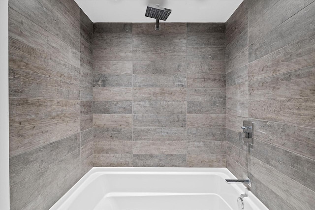bathroom featuring a combined bath / shower with rainfall shower