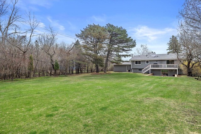 view of yard featuring stairs and a wooden deck