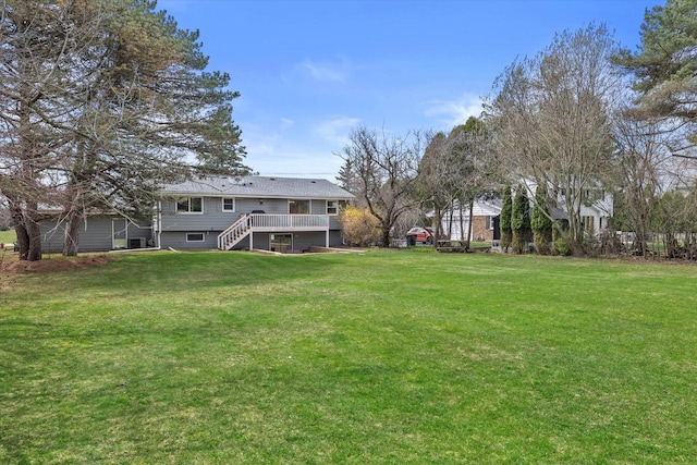 view of yard featuring stairs and a deck