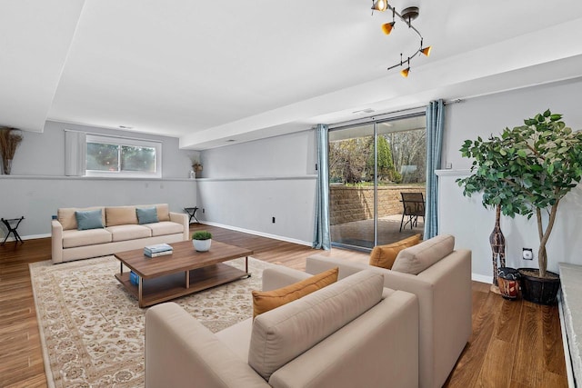 living room featuring baseboards, a wealth of natural light, and wood finished floors
