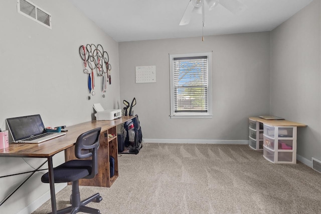 carpeted home office with visible vents, a ceiling fan, and baseboards