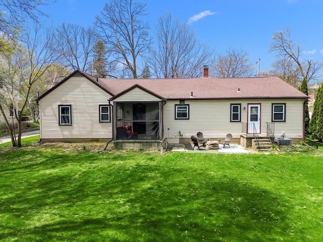 rear view of property featuring central AC, a chimney, a patio, a yard, and a fire pit