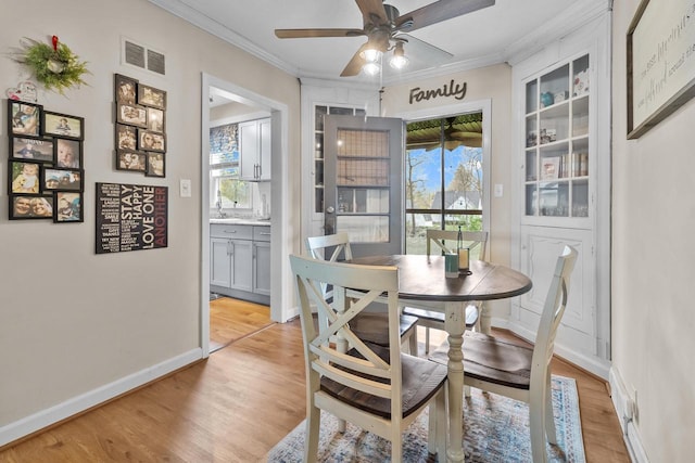 dining room with plenty of natural light, light wood finished floors, and visible vents