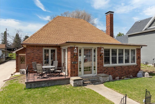 233 N 1st St, Princeton, WI 54968 - rear view of property featuring brick siding, roof with shingles, a yard, and a patio area