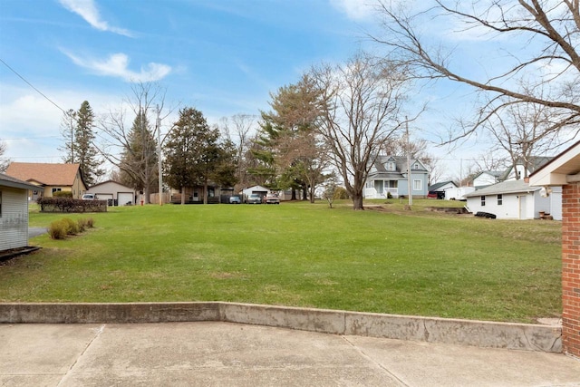 233 N 1st St, Princeton, WI 54968 - view of green lawn featuring a residential view and a garage