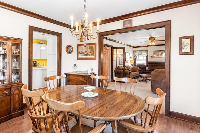 233 N 1st St, Princeton, WI 54968 - dining space featuring ornamental molding, wood finished floors, baseboards, ceiling fan, and a chandelier