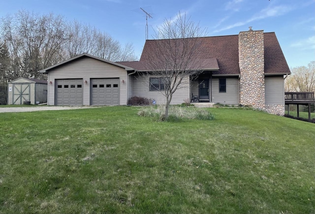 view of front of house featuring roof with shingles, a storage unit, an attached garage, a front lawn, and driveway