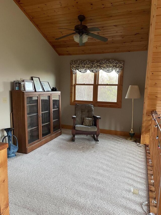 living area featuring carpet flooring, ceiling fan, baseboards, lofted ceiling, and wood ceiling