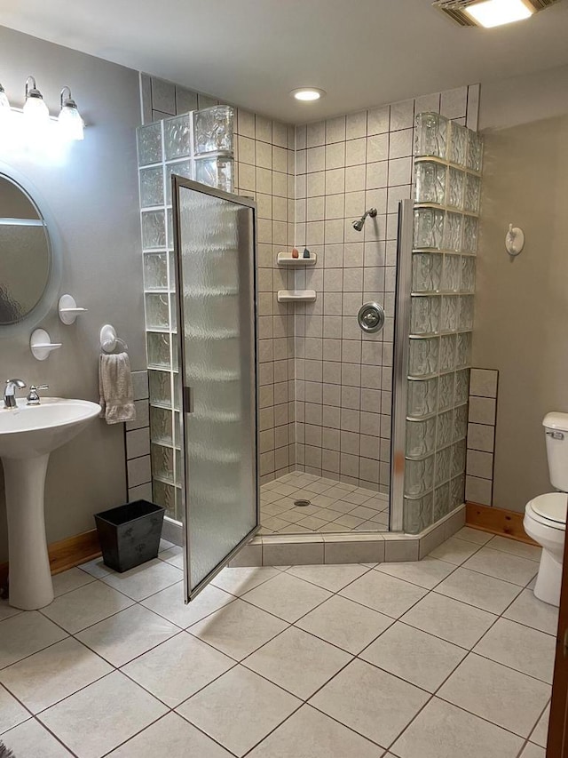 full bath with visible vents, a sink, a walk in shower, tile patterned floors, and toilet
