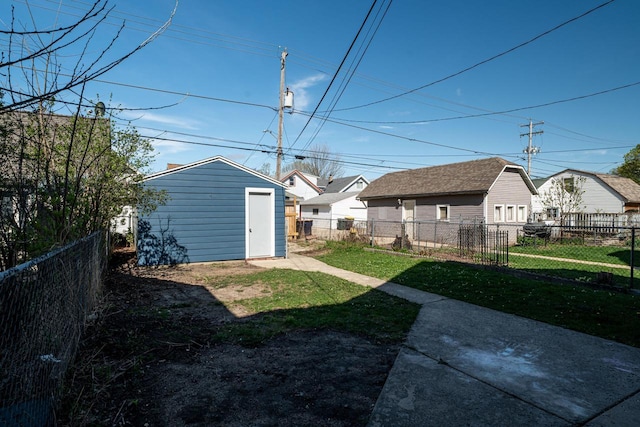 view of yard with a storage shed, an outdoor structure, and a fenced backyard