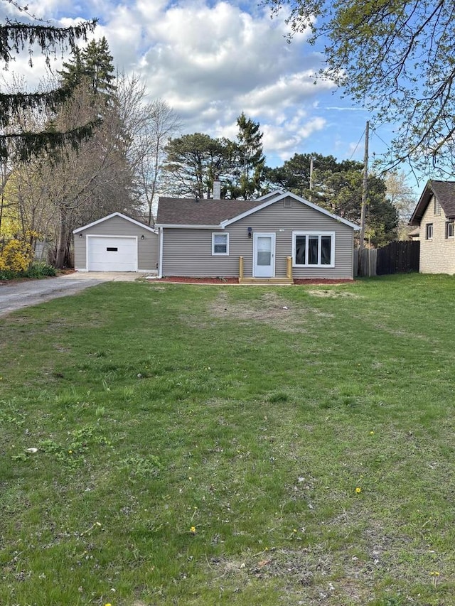 1742 Kremer Ave, Racine, WI 53402 - view of front of house featuring asphalt driveway, a detached garage, an outdoor structure, and a chimney