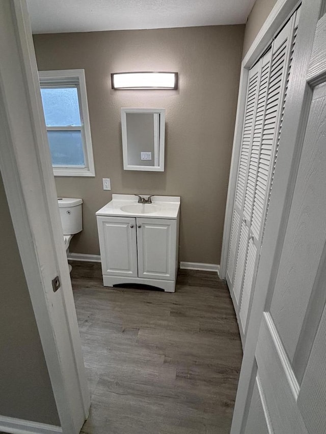 1742 Kremer Ave, Racine, WI 53402 - bathroom featuring toilet, wood finished floors, baseboards, and vanity