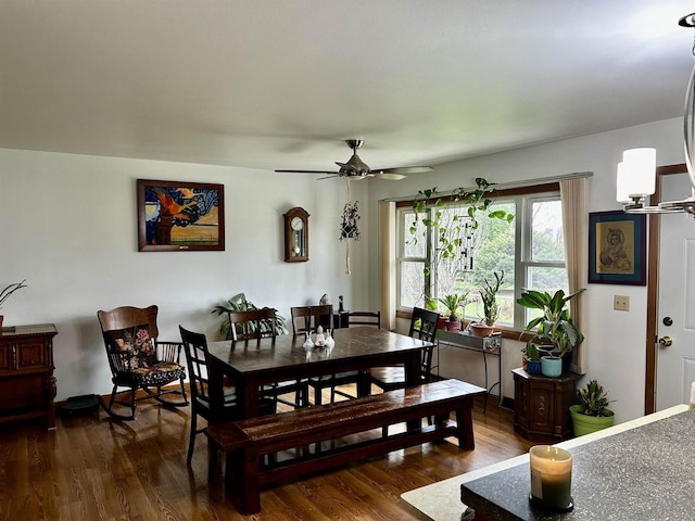 dining space with dark wood-type flooring and ceiling fan with notable chandelier