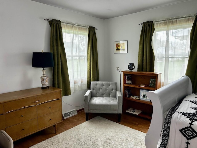 bedroom featuring dark wood-style flooring and visible vents