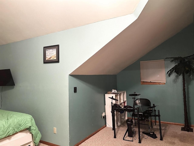 interior space with baseboards, carpet flooring, and vaulted ceiling