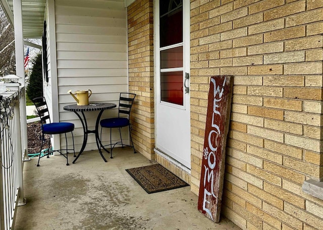 doorway to property with brick siding