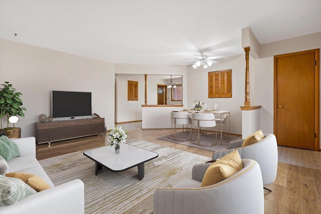living room with light wood-style flooring and ceiling fan