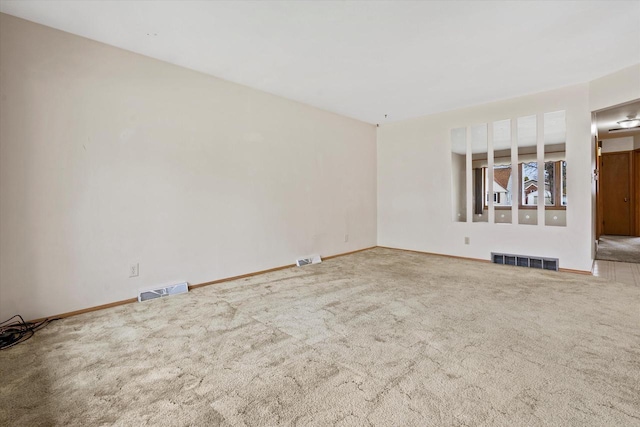 unfurnished living room with carpet floors, baseboards, and visible vents
