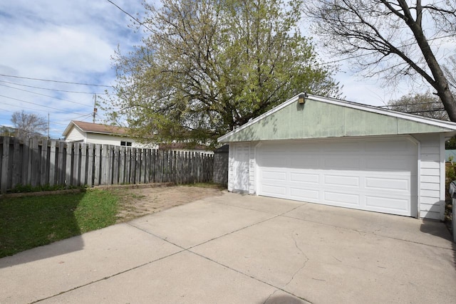 detached garage featuring fence