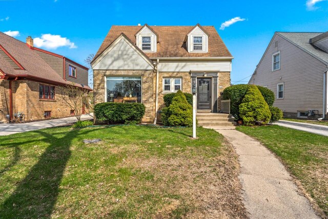 view of front of house with brick siding and a front yard