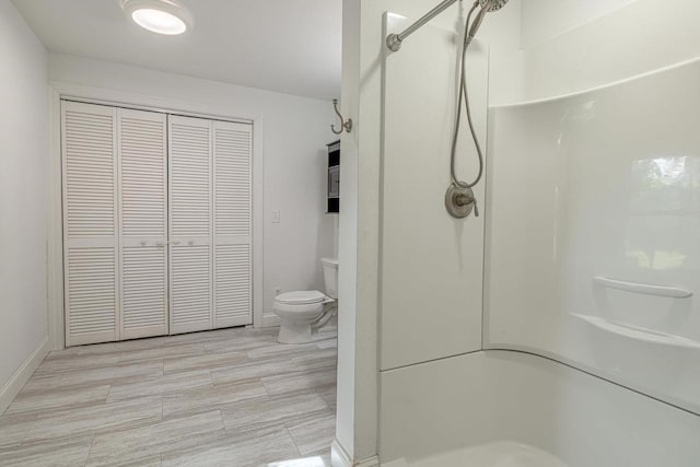 2334 16th Ave, Monroe, WI 53566 - full bathroom with toilet, a closet, walk in shower, and baseboards