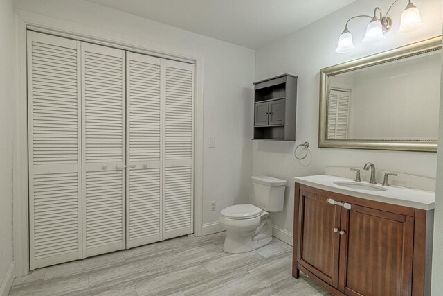 2334 16th Ave, Monroe, WI 53566 - bathroom featuring a closet, toilet, vanity, and baseboards