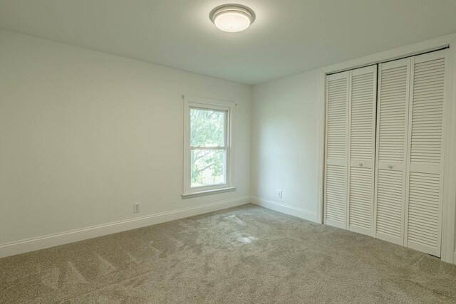 2334 16th Ave, Monroe, WI 53566 - unfurnished bedroom with carpet, baseboards, and a closet