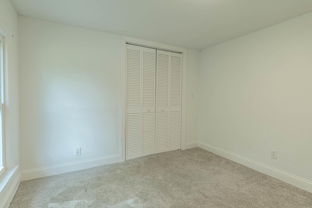 2334 16th Ave, Monroe, WI 53566 - unfurnished bedroom with carpet, a closet, and baseboards