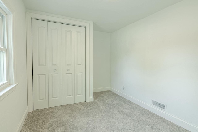 2334 16th Ave, Monroe, WI 53566 - unfurnished bedroom with carpet flooring, a closet, and baseboards