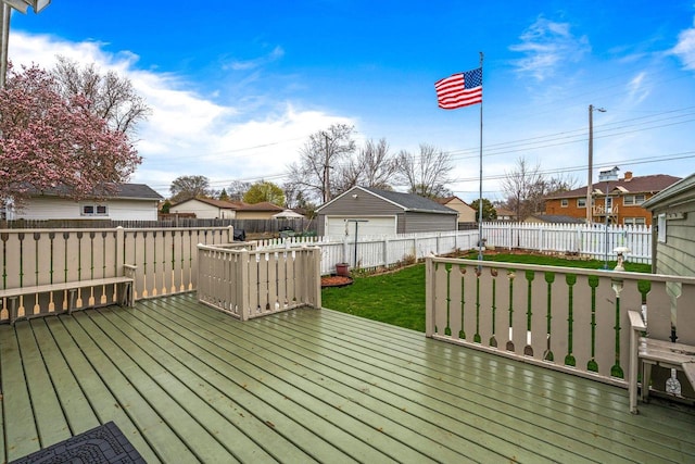 deck featuring a yard, fence, a residential view, and a garage