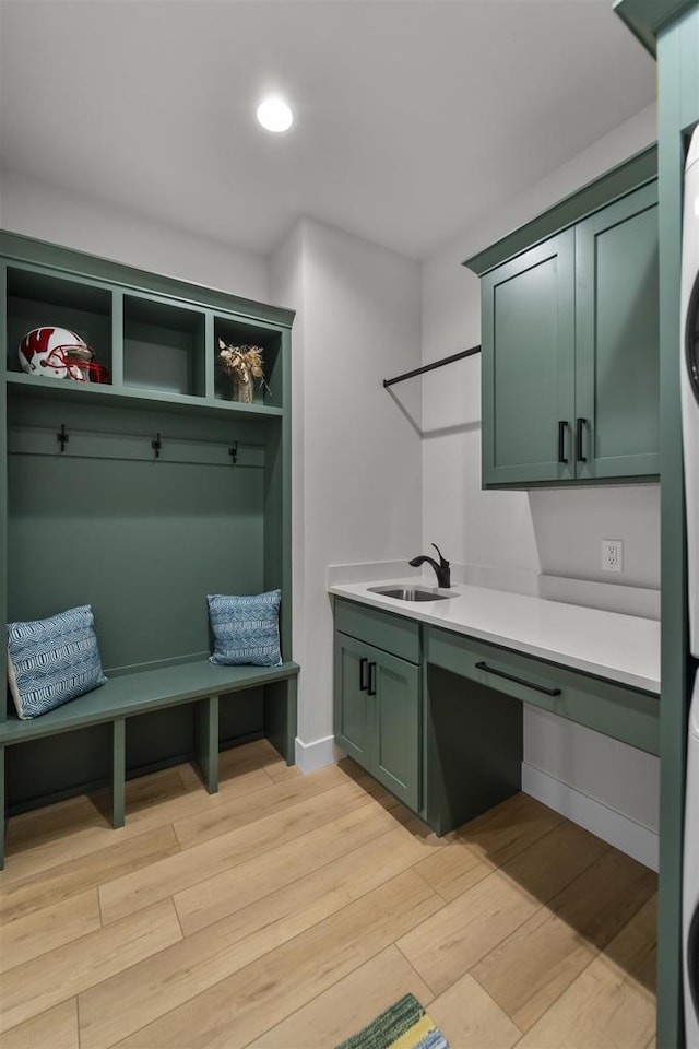 1205 Thistle Dew Ln, Waunakee, WI 53597 - clothes washing area with cabinet space, stacked washer / drying machine, light wood-style flooring, baseboards, and recessed lighting