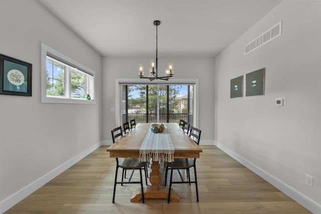 1205 Thistle Dew Ln, Waunakee, WI 53597 - dining room with plenty of natural light, a chandelier, and baseboards