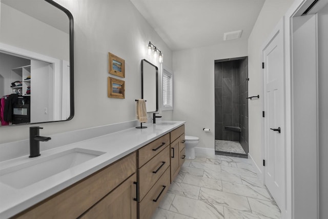 1205 Thistle Dew Ln, Waunakee, WI 53597 - bathroom with marble finish floors, toilet, a tile shower, double vanity, and baseboards