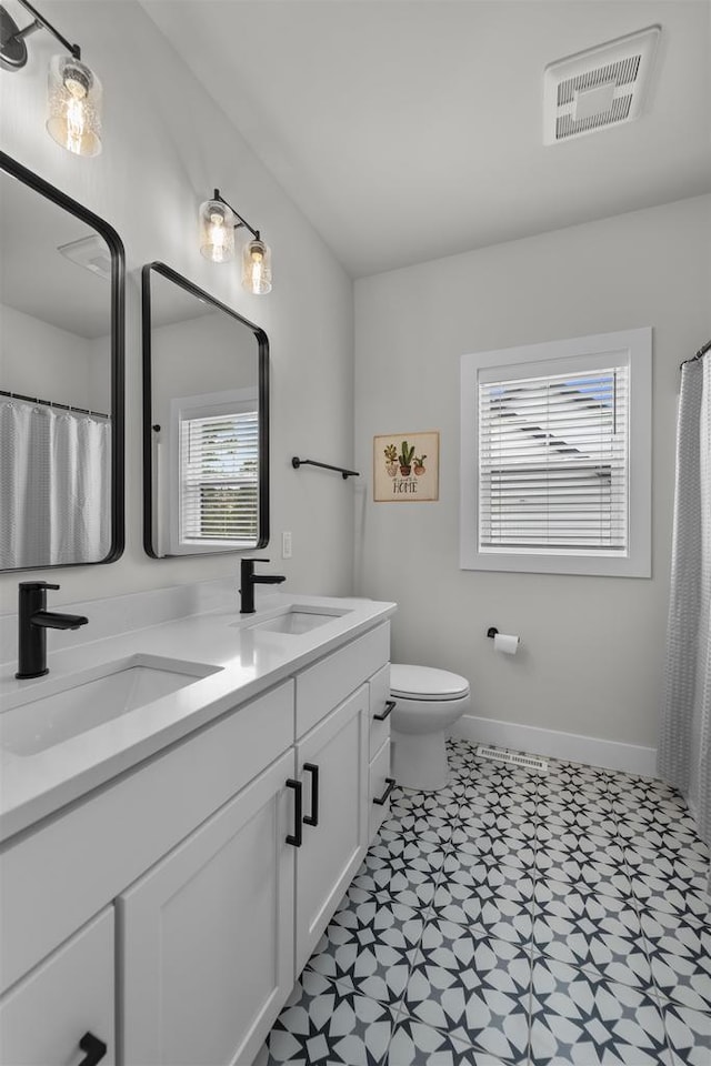 1205 Thistle Dew Ln, Waunakee, WI 53597 - full bathroom with tile patterned floors, double vanity, toilet, and baseboards